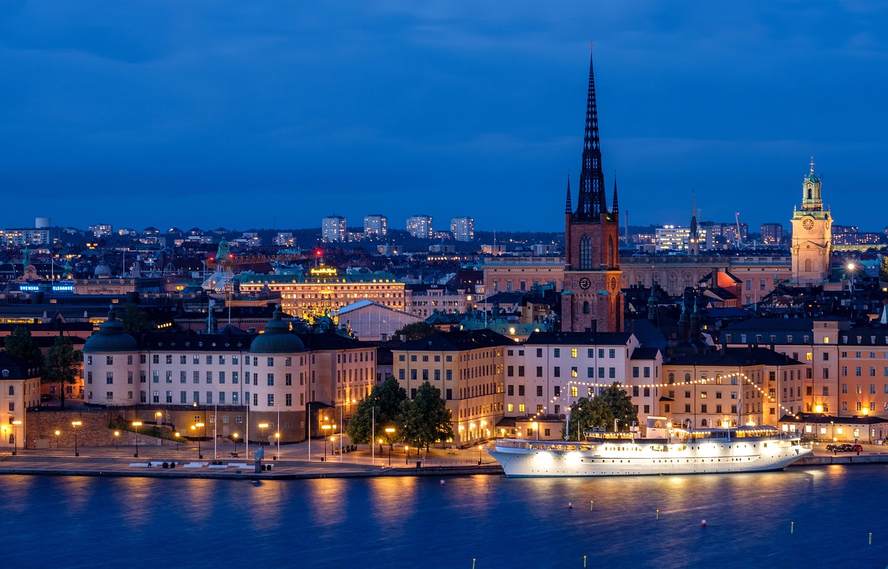 city, cityscape, waterfront, illuminated, ship, architecture, skyline, historic center, church, steeple, water, sea, night, evening, twilight, lights, mirroring, stockholm, sweden, nature, scandinavia